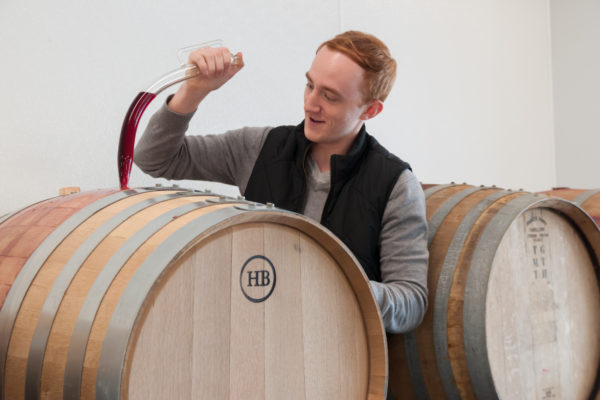 groom drawing wine from barrel